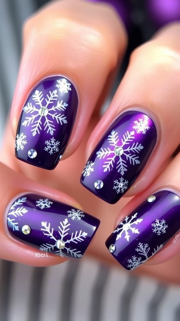 Elegant purple Christmas nail art with snowflakes and rhinestones on a blurred background.